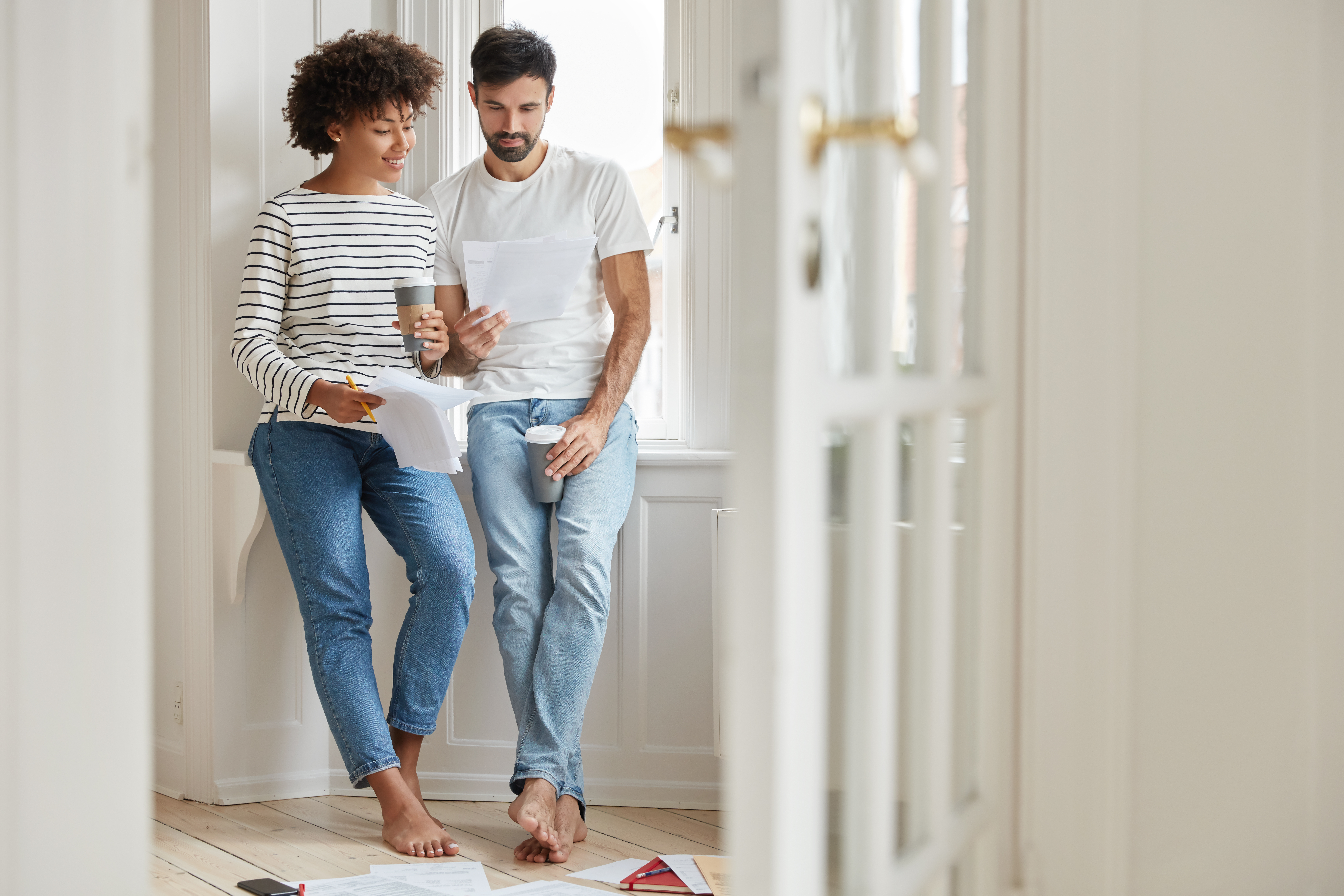 Husband and wife completing paperwork for the sale of there home